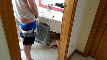 Stepsister receives facial cumshot through a hole in the sink