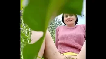 Naked horny MILF in a chamomile field masturbates, pisses and wards off a wasp / Angela-MILF