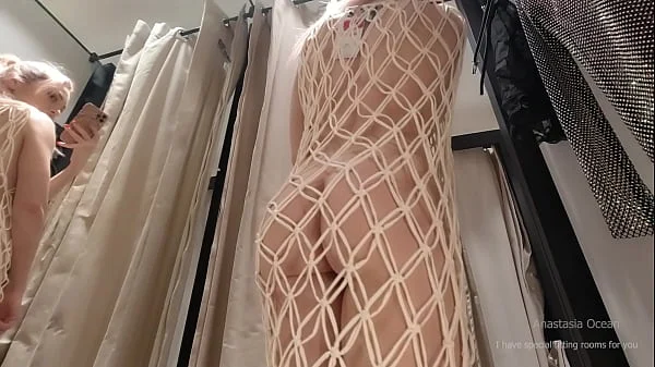 I try on clothes in fitting room with open curtain. Hotwife