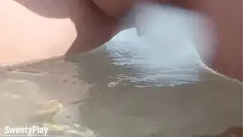 Shaved pussy peeing on public beach