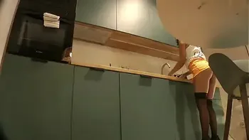 Panties Flash of a Cute Sexy Housewife on High Heels and Stockings in a Mini Short Skirt