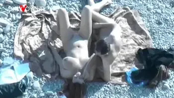 Beach Voyeur. Hot babe with big natural tits gives head on a public beach