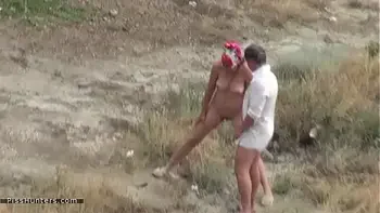 Couple voyeured peeing on nude beach