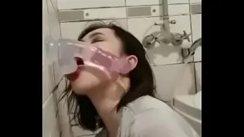 Asian deepthroating a dildo