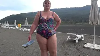 BBW with big booty in tight jeans is dressing in a public dressing room on the beach. Fetish.