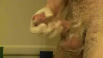 Hubby washing beautiful cock in the shower and it went off
