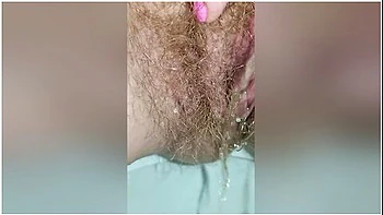Detailed Close-up Footage Of A Hairy Pussy Girl Urinating From Her Pee Hole And Farting Loudly