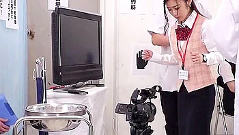 She is topless and her breasts are fondled and her nipples are pinched, while the male employees look on with grins.