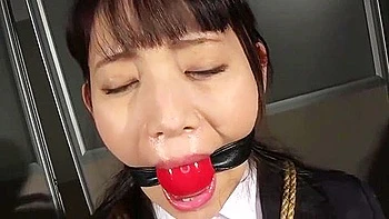 She is tied up, her breasts are exposed, touched, and a vibrator is inserted into her.