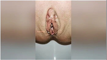 Beautiful Bald Pussy Of Petite Milf Makes The Big Powerful Urine Fountain Close Up
