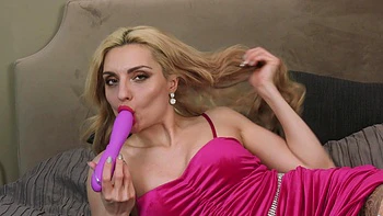 Caty Kiss in sexy lingerie and stockings, teasing with her toys.